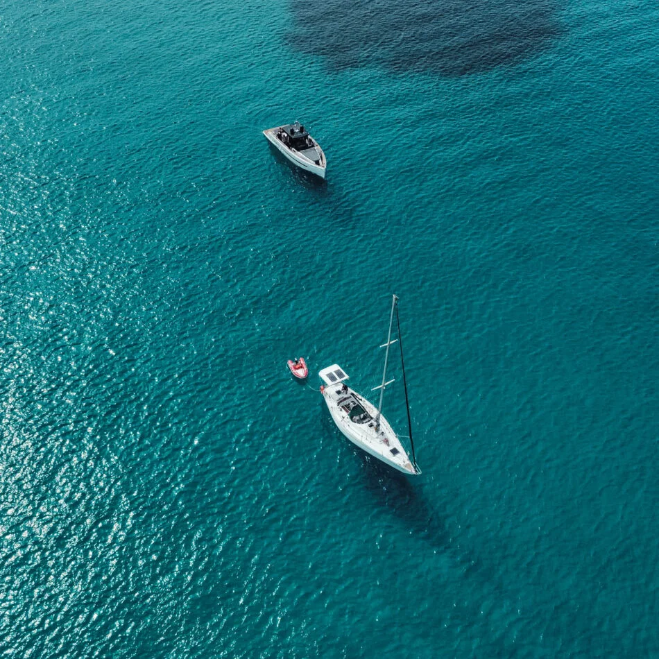 Private sailboats over turquoise water in Ibiza and Formentera