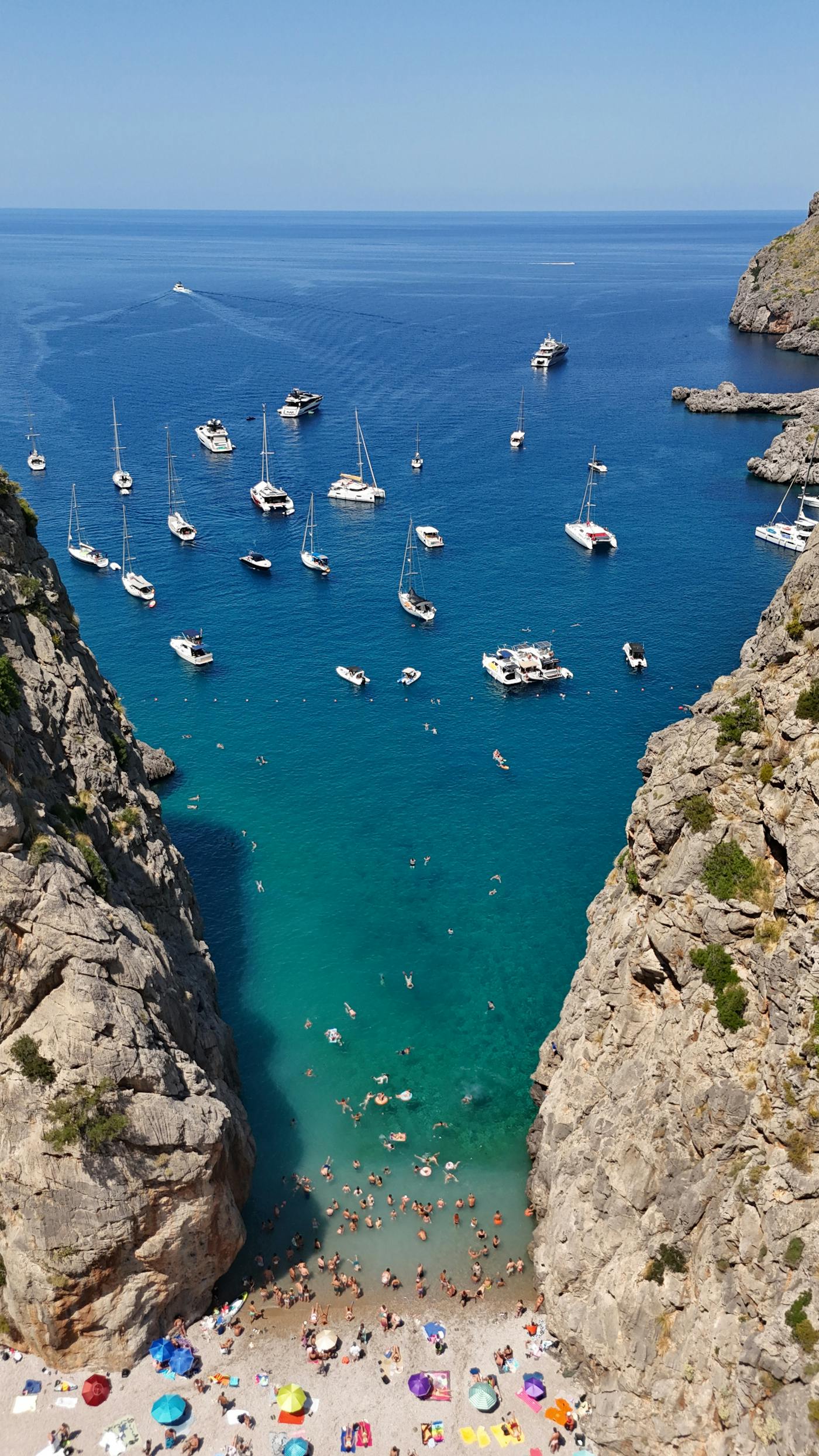 Ibiza cove with anchored boats and clear water