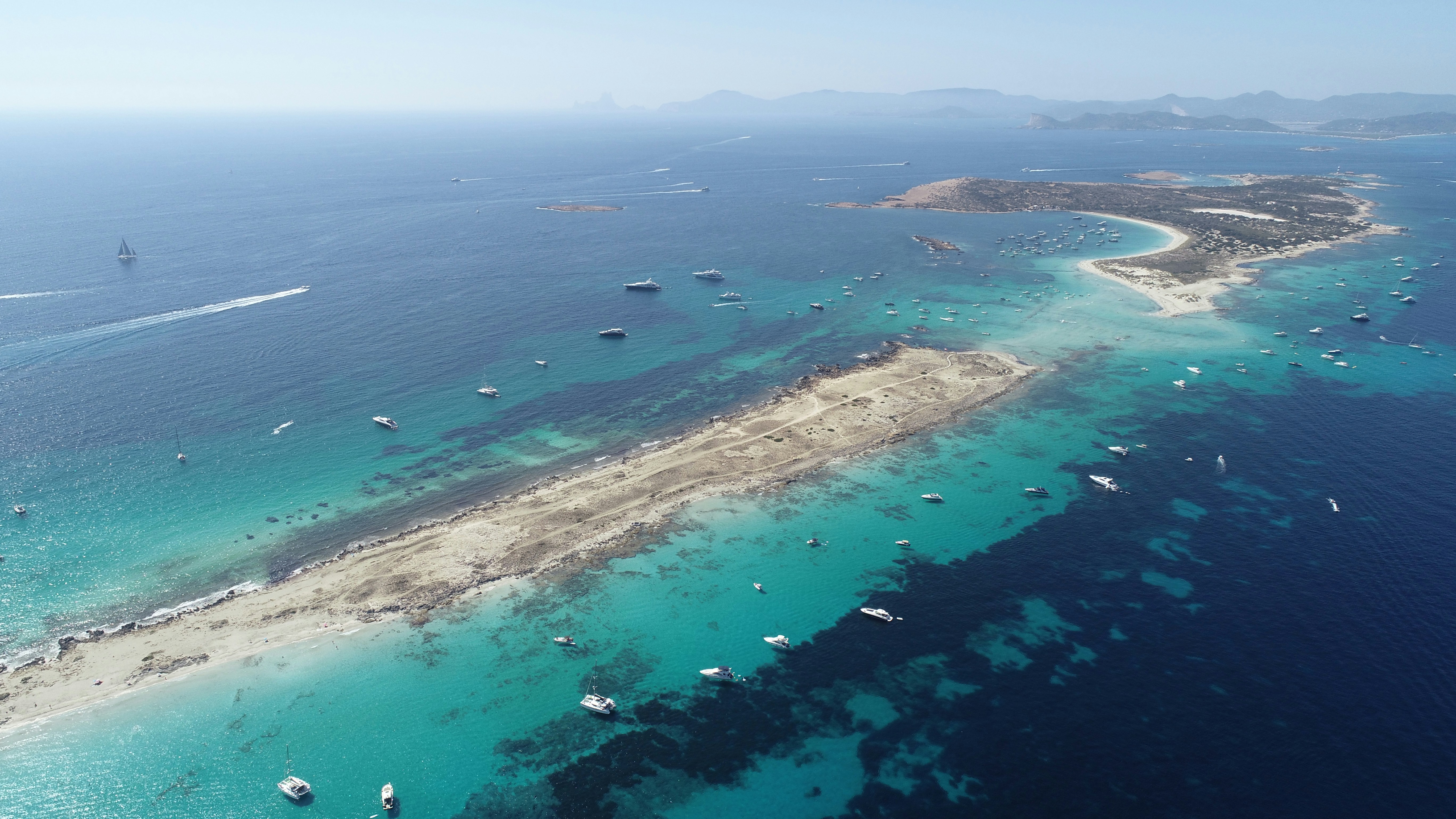 Wide aerial view of Formentera and turquoise water from above