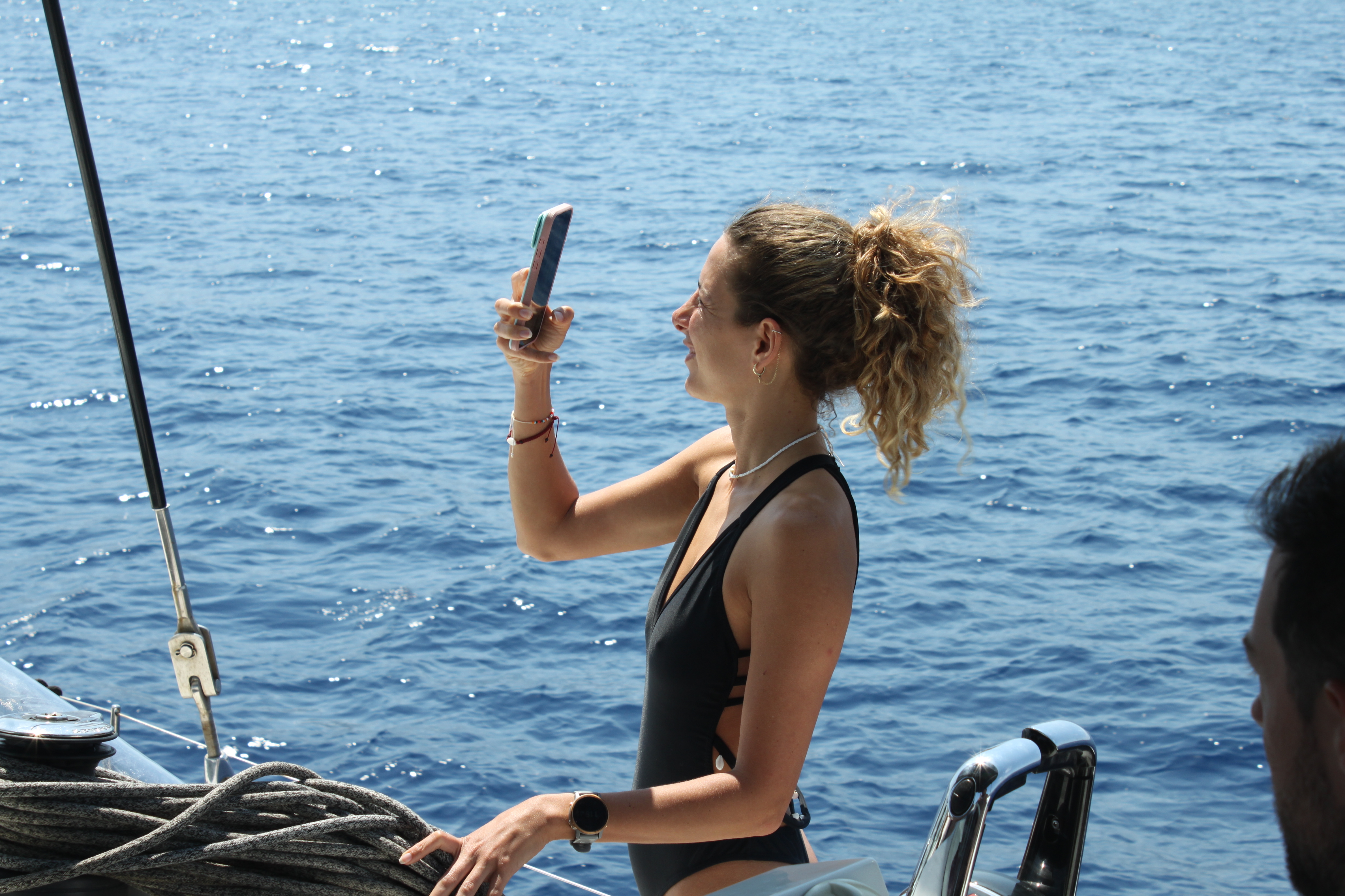 Guest taking a photo onboard during a private sailing day