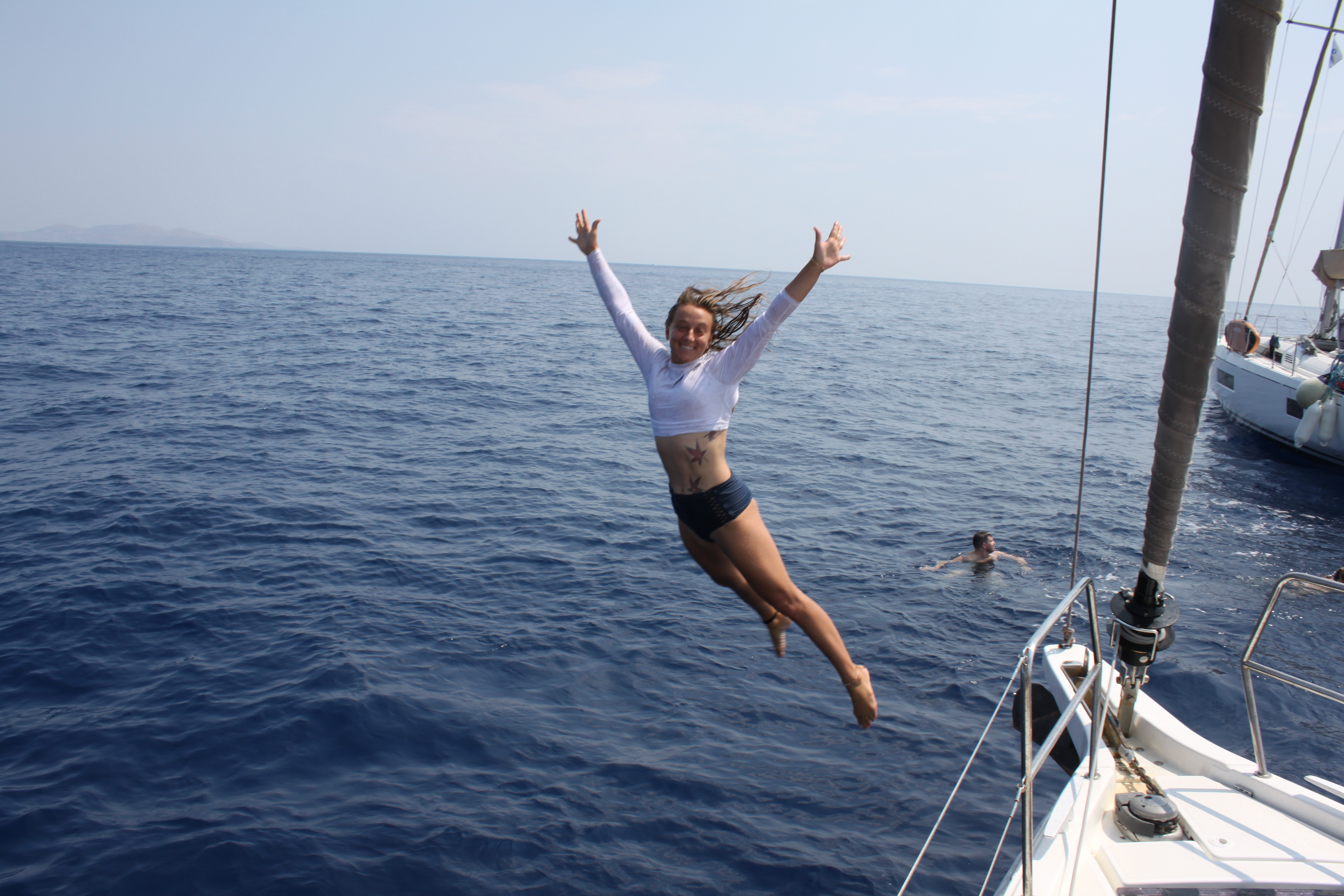 Guest diving into the sea during a Bora Sailing trip