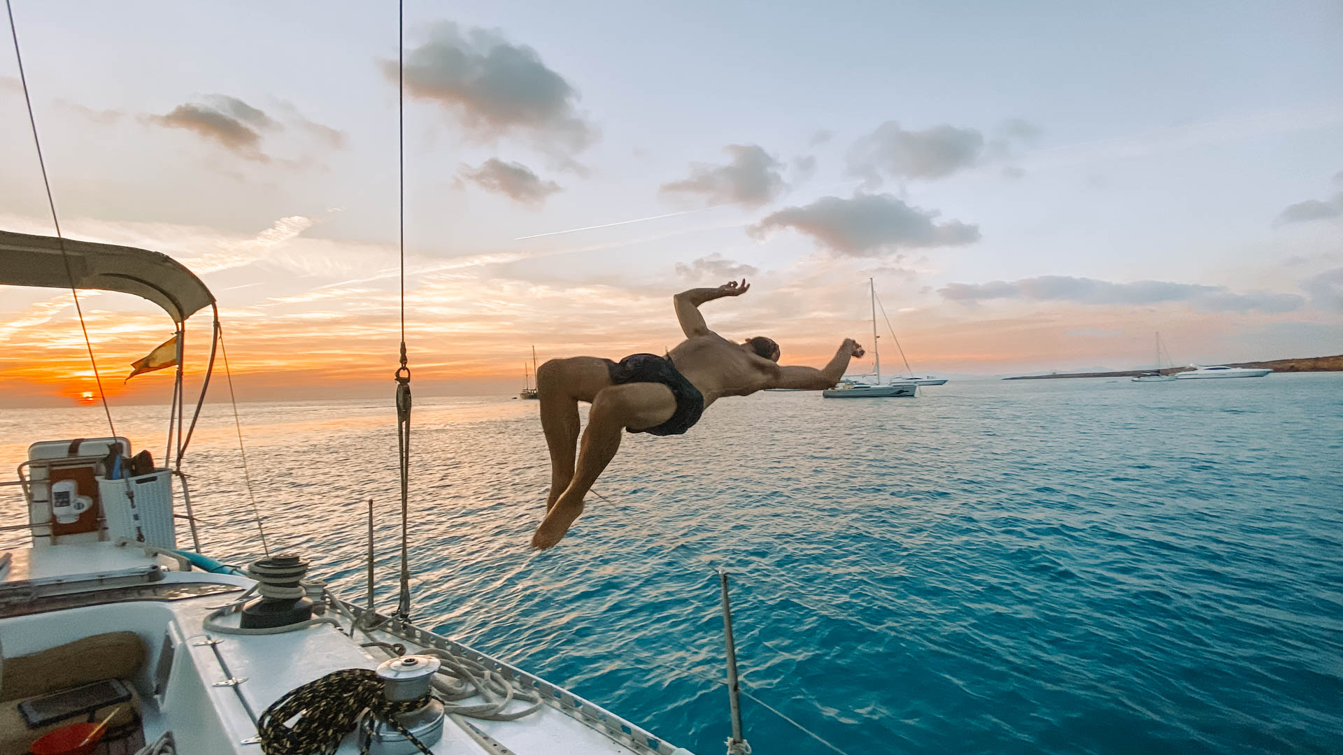 Sunset jump from the boat into turquoise water